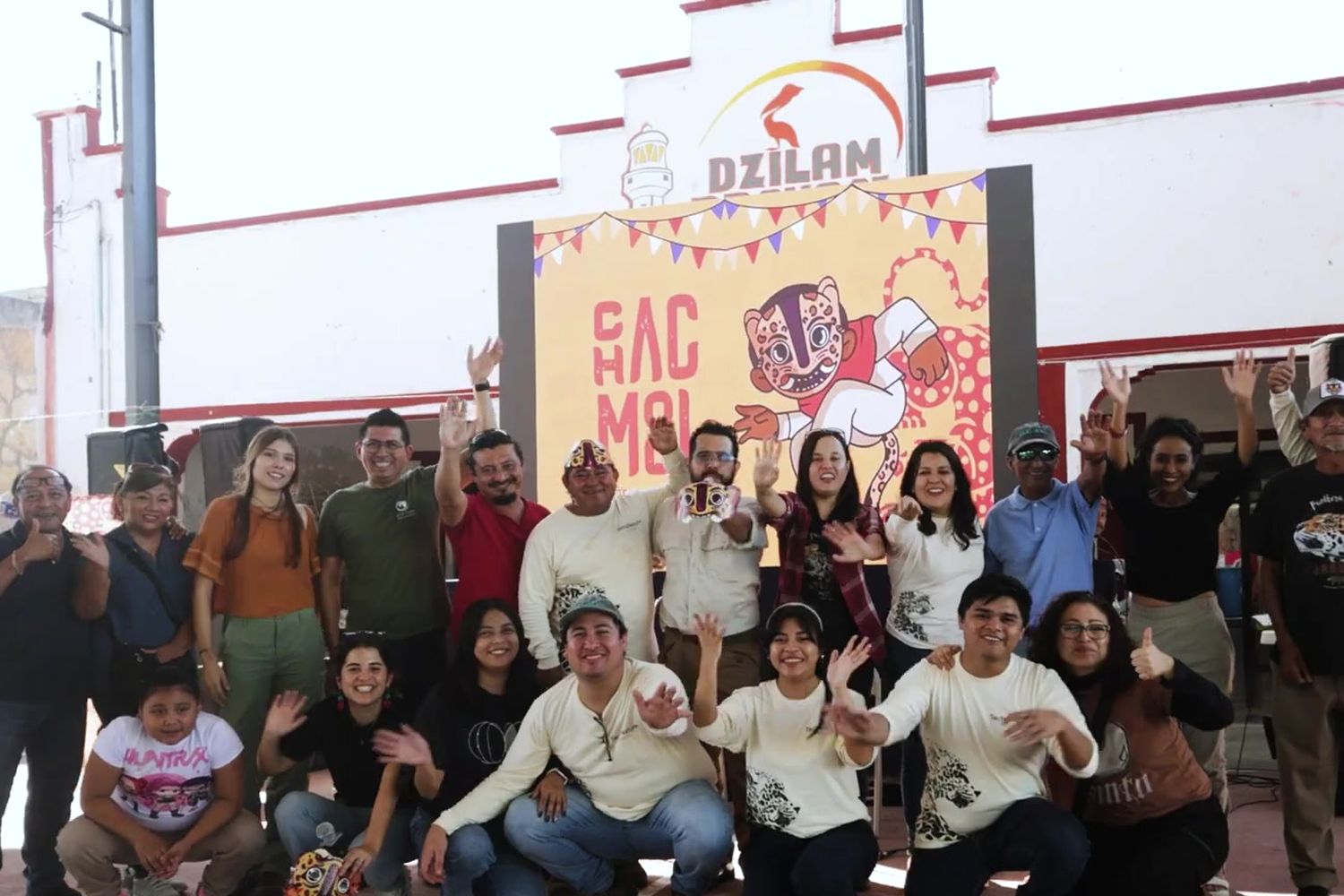Large group in front of the Jaguar Festival mural