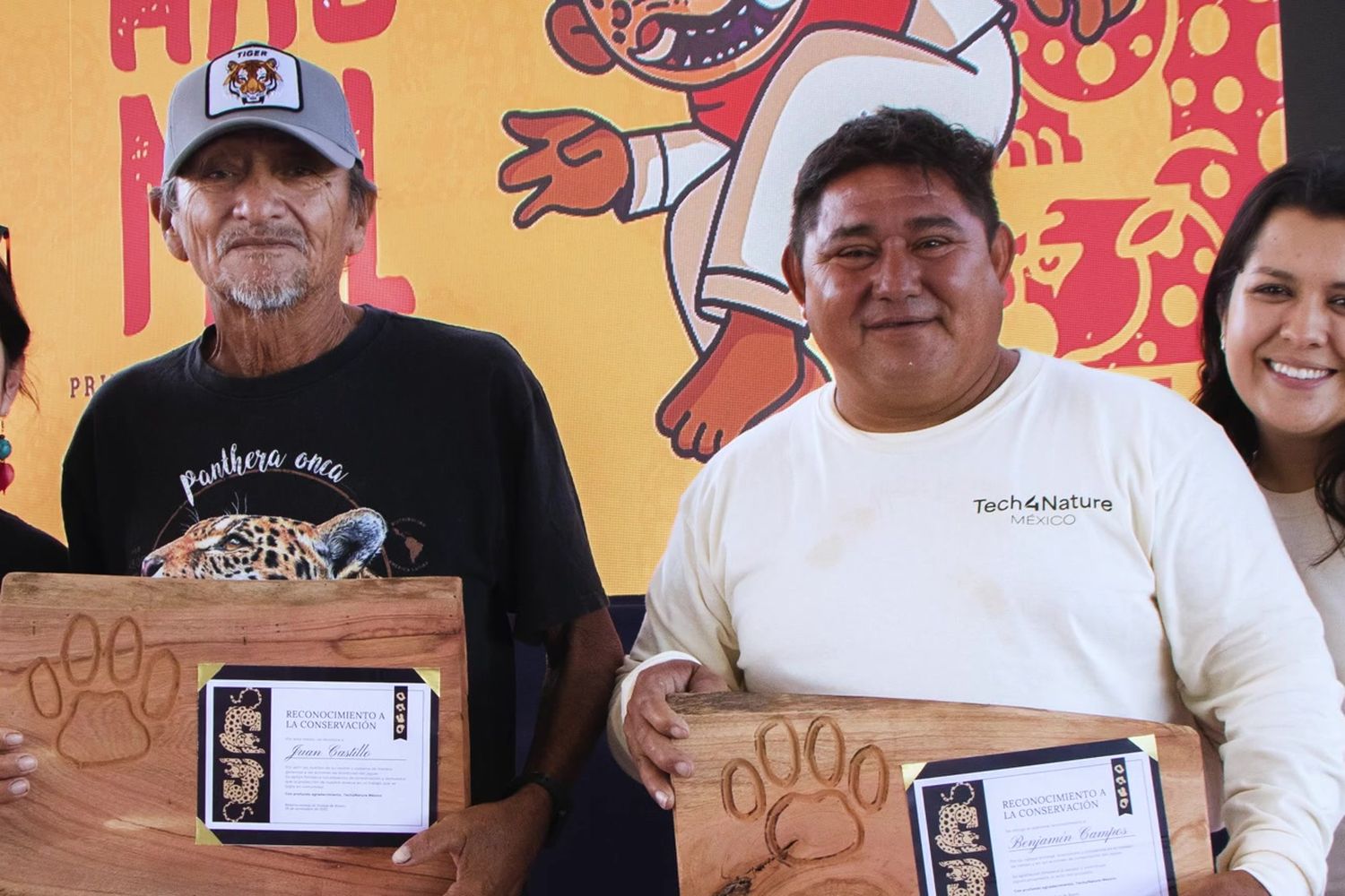Community monitors receive wooden awards with jaguar tracks