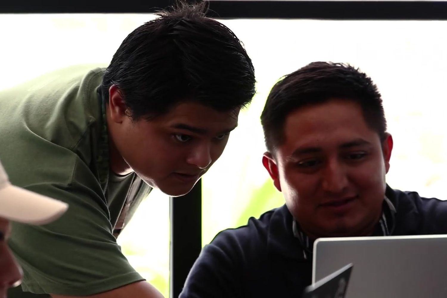 Two participants review results on a laptop